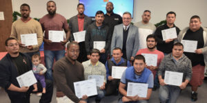 A bunch of fathers holding certificates